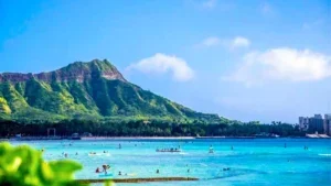 Tourists enjoying the beach at Diamond Head State Monument - Oahu, Hawaii, USA